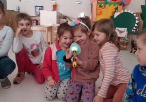 Dziewczynki podświetlają jajo latarką