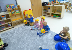 Dzieci zakładają na głowy czapki - kaczuszki.