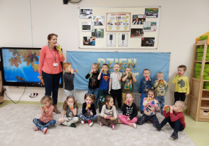 Dzieci prezentują wykonaną własnoręcznie pomoc do ćwiczeń oddechowych