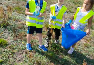 dzieci trzymają śmieci