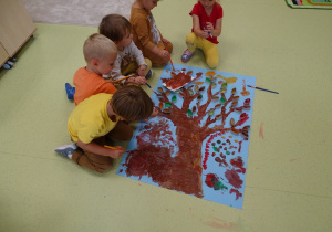 Dzieci podczas wykonywania jesiennego drzewka
