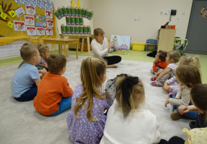 03 Pani bibliotekarka czyta dzieciom książkę i pokazuje ilustracje