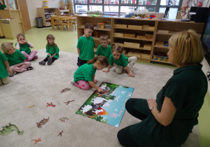 28 Dzieci układają planszę o dinozaurach