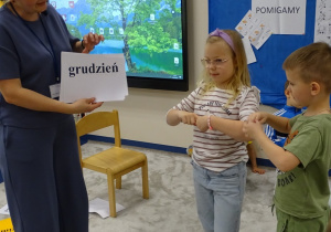 dzieci pokazują miesiace, dni tygodnia paluszkami