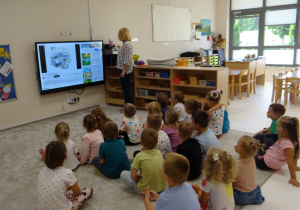 05 Dzieci siedzą przed tablicą interaktywną