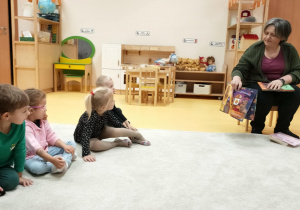 Pani pokazuje dzieciom ilustracje.