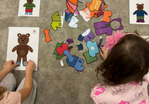 Dzieci wybierają ubranka dla misia