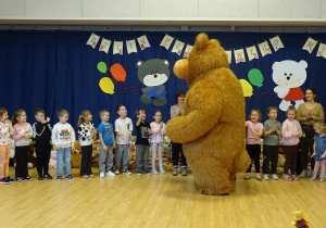 Miś wita się z dziećmi.