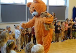 Miś wita się z dziećmi.