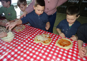 Dzieci układają ulubione dodatki na pizze