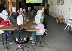 Dzieci oglądają bajkę o powstawaniu chleba.