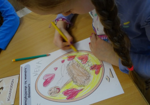 Chłopiec pokazuje rysunek swojego dinozaura.