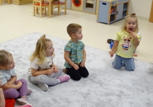 Dzieci wykonują kolejne ćwiczenie logopedyczne