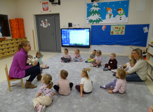 Dzieci z nauczycielką słuchają bajki logopedycznej