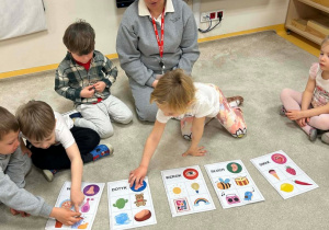 Dziewczynka dobiera odpowiedni obrazek zmysłu