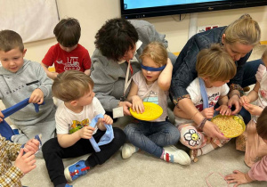 Nauczycielka i logopedka pilnują, by kolejne dzieci wykonały zadanie