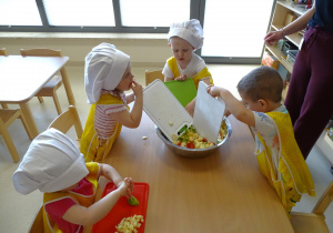 dzieci zrzucają sałatkę do miski