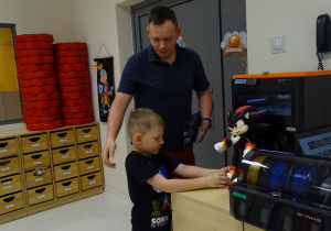 05 Michał z Tatą pokazują wytwory ich pracy pochodzące z drukarki 3D
